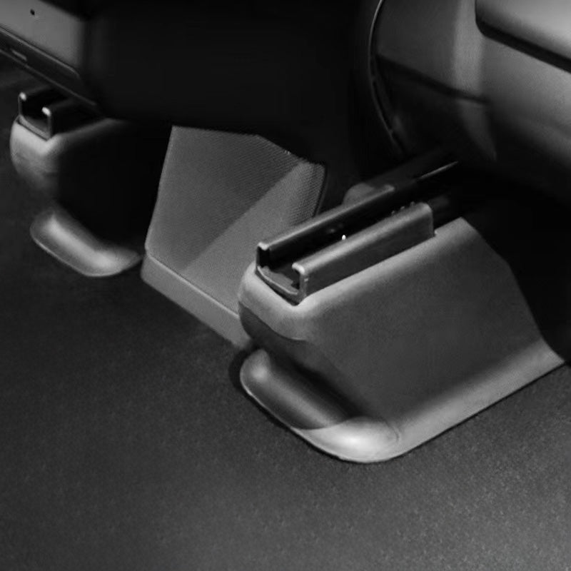 Close-up of the front under seat carpet protector fitted in Model Y L