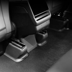 Front under seat carpet protectors installed beneath the front seats of Model Y L