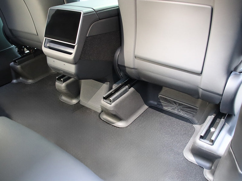 Rear under seat carpet protectors installed in the second-row footwell of Model Y L