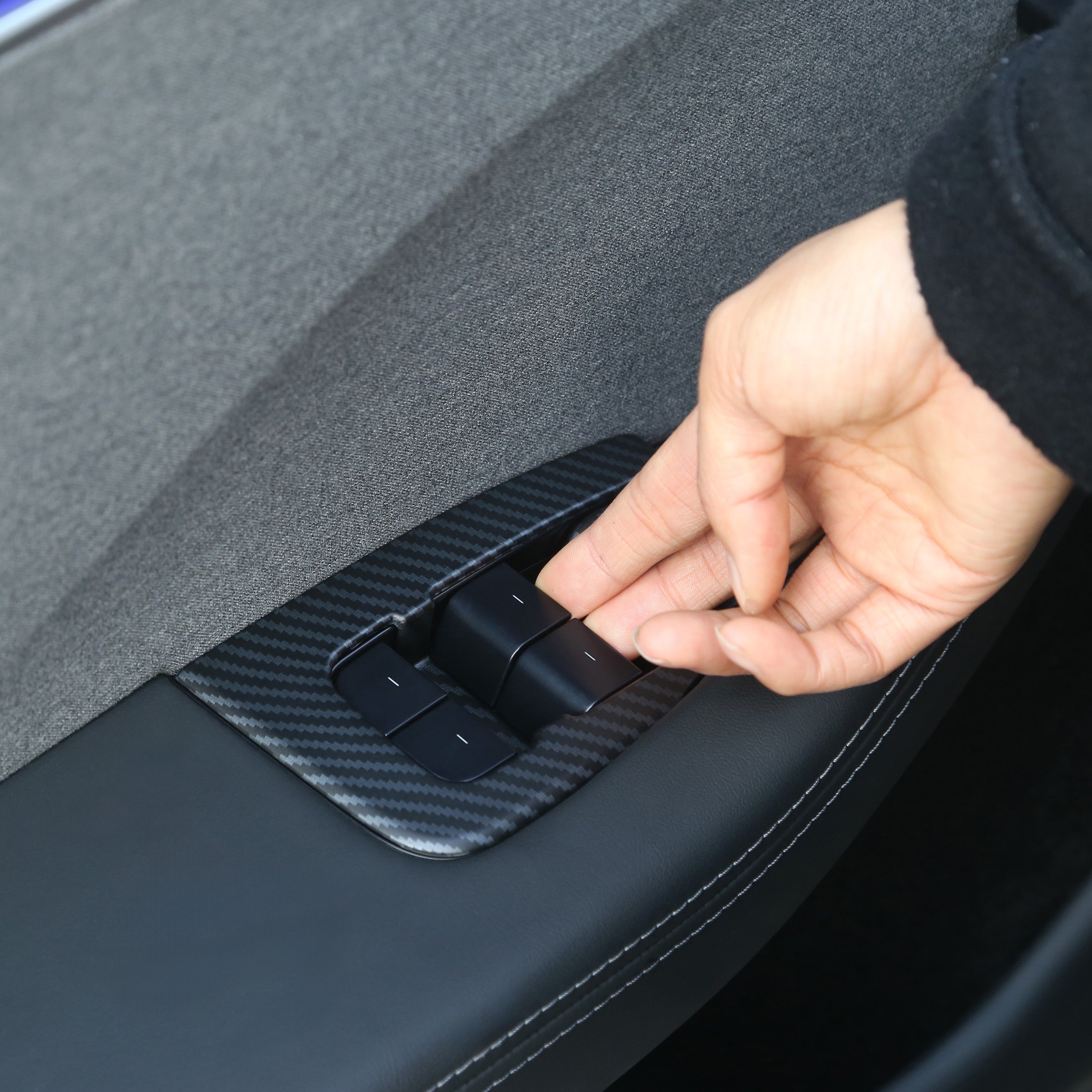 Installing the Matt Carbon Fibre window lift switch button cover on Model 3
