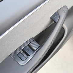 Matt Carbon Fibre window lift switch button cover installed on the front door of Model 3