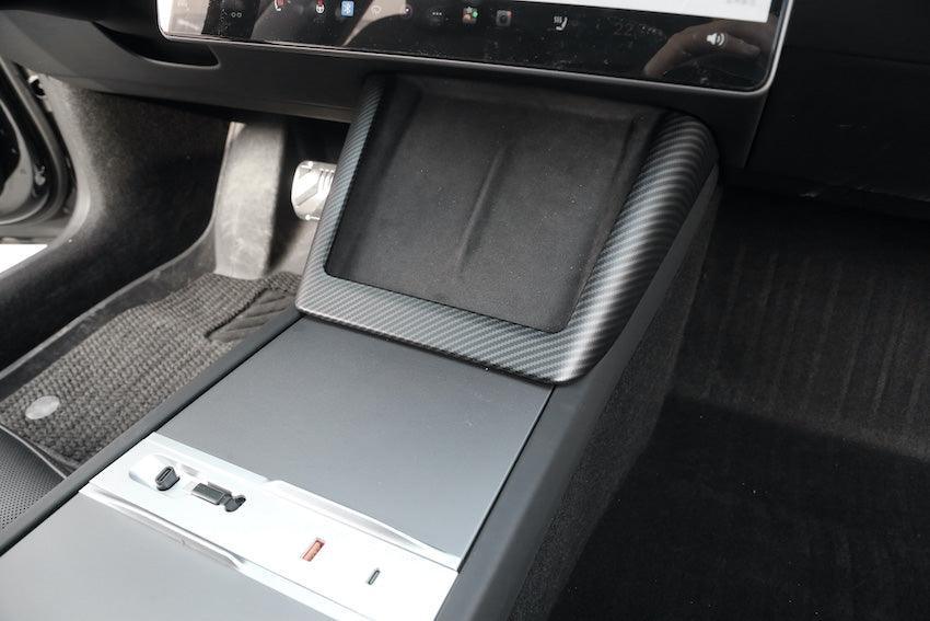 Carbon fibre wireless phone charger surround installed on the centre console