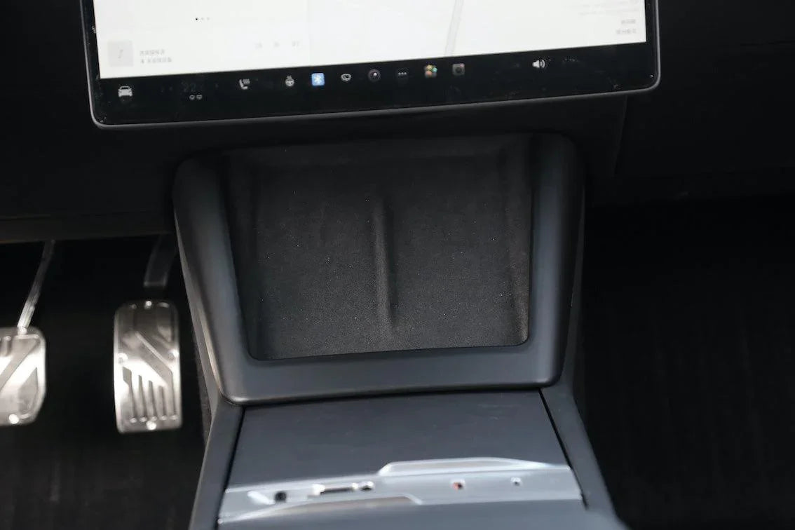 Close-up of the matt black wireless phone charger surround on the centre console