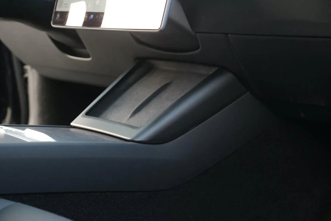 Matt black wireless phone charger surround enhancing the Tesla centre console