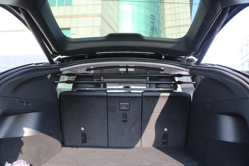 Cargo and pet barrier installed behind the rear seats of Model Y